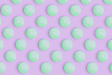 Macaroons pattern on colored background, a pattern of colorful french cookies macarons. Green french cookies macarons on purple background. Gift for congratulations.