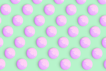 Macaroons pattern on colored background, a pattern of colorful french cookies macarons. Purple french cookies macarons on purple background. Gift for congratulations.