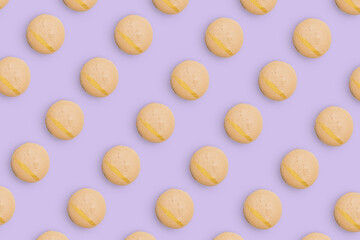 Macaroons pattern on colored background, a pattern of colorful french cookies macarons. Beige french cookies macarons on purple background. Gift for congratulations.