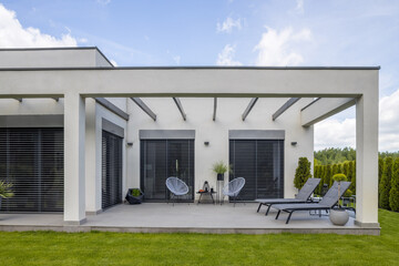 Outside view of elegant suburban house with big window green lawn