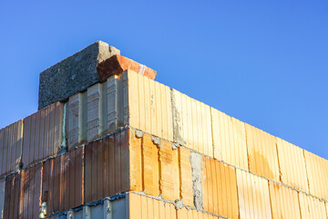 view of the corner of a new building, built from building blocks on a blue sky background