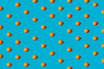 Fruit pattern of fresh orange slices on cyan blue background. Top view. Copy Space. art design, creative summer concept. citrus in minimal flat lay style. Banner, desktop, print, wallpaper. 