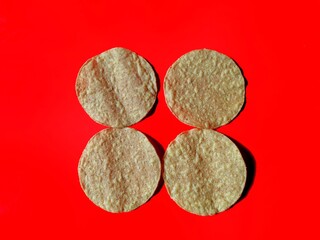 Fried corn tortillas on red background, typical food of Guatemala
