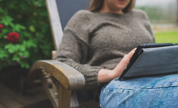 Woman using tablet pc in the countryside. Good internet communication concept.