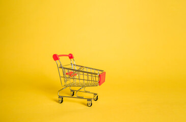 Empty metal food cart on yellow isolated background with space for text