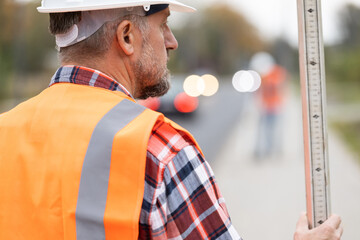 Closeup of road construction worker in orange vest an helmet