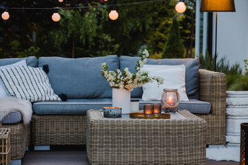 Summer evening on the patio of beautiful suburban house with garden