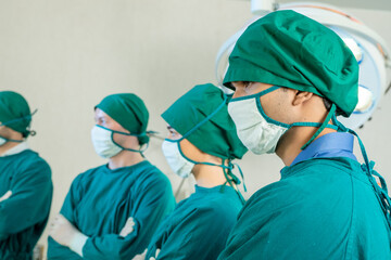 Portrait of medical professional team standing in operation room.