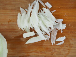 Fototapeta na wymiar the cook cuts onions on a wooden Board. poster.