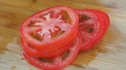 juicy tomatoes cut into circles on the Board.