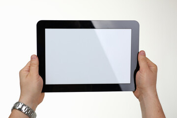 Close up of male hands showing modern tablet isolated on white background. Copy space on screen. Technology concept