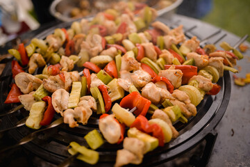 The chef grills the skewers in the yard