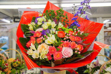A bouquet of bright flowers roses gerberas irises, structures, and designs. Floriculture, agriculture.