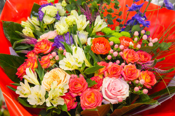 A bouquet of bright flowers roses gerberas irises, structures, and designs. Floriculture, agriculture.