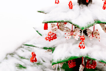 Step by step instruction how to make a Christmas tree. The final close-up view of the spruce decorated with cotton wool and toys made from colored macaroni.
