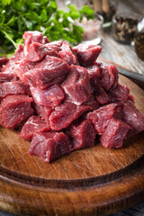 Beef stew prepared on a chopping board.