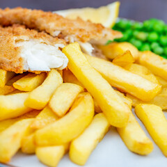 Traditional English Food such as Fish and Chips with green peas served in the Pub or Restaurant