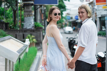 Fototapeta premium summer holiday of a attractive tourist couple walking on shopping centre in asia