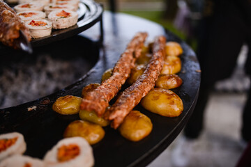 Roasted minced kebab with rolled white meat stuffed with vegetables. Barbecue and outdoor party