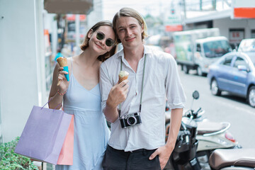 summer holiday of a attractive tourist couple walking on shopping centre in asia