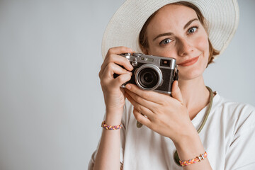 portrait of a woman photographer going on vacation over white background