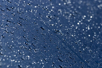 Water drops on blue metallic surface. Abstract blue water drops background.