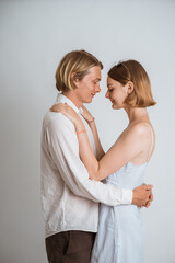 attractive couple embracing each other over white background