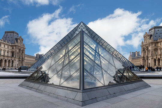 Paris, France - March 17, 2018: View of famous pyramid of Louvre museum with reflections