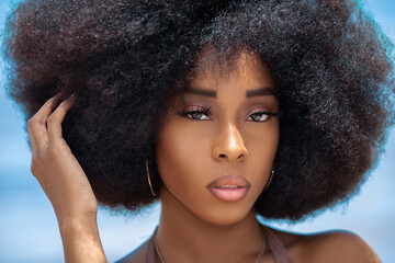 A head shot of a sensual looking attractive young black female with gorgeous makeup and a beautiful...