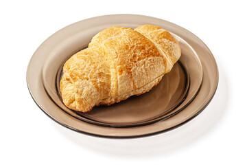 freshly baked flavorful crispy croissant on a glass plate isolated on white