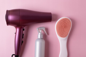 different hairdresser's items or haircare objects on pink background. minimalism style.