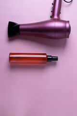 different hairdresser's items or haircare objects on pink background. minimalism style.