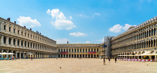 Venice, Italy - june 29th 2020 - very little tourists crossing the San Marco square in the center of Venice on a sunny Corona day in summer