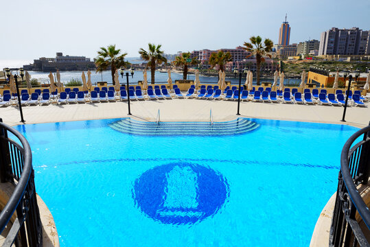 ST JULIANS, MALTA - APRIL 24: The swimming pool at Corinthia St Georges Bay luxury hotel on April 24, 2015 in St Julians, Malta. More then 1,6 mln tourists is expected to visit Malta in year 2015.