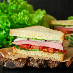 sandwich sausage, vegetables,  tamato, lettuce, sauce fast food
serving size. food background top view copy space for text organic healthy eating