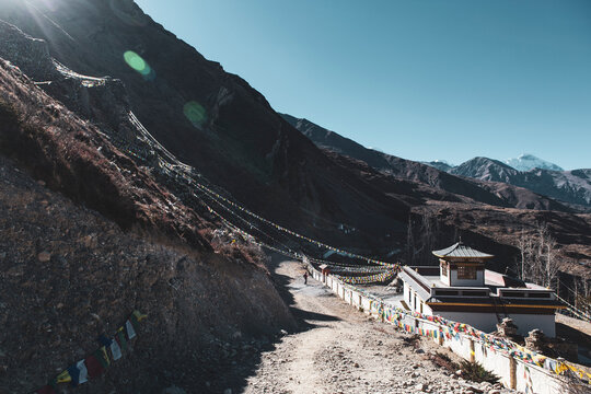 Muktinath temple prayer flags at Mustang, Nepal. Rocky mountain side on a sunny day and blue sky.