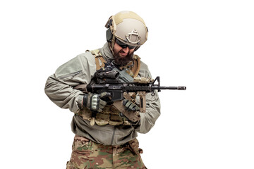 American soldier in military equipment with a rifle on a white background reloads weapons, commando in uniform in action