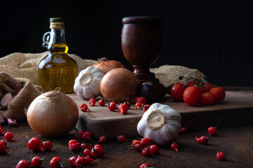 Wooden mortar and spices in a rustic arrangement on wood. selective focus