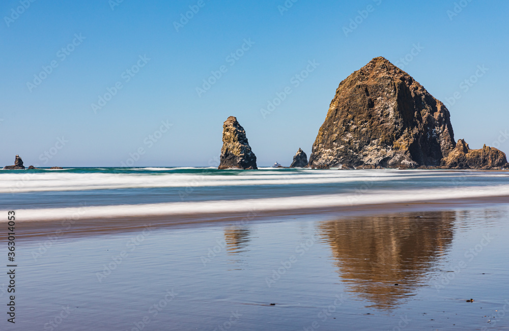Wall mural long exposure smooths waves and creates a unique look around haystack rock on cannon beach in oregon