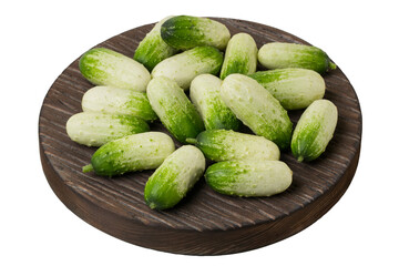 Fresh little cucumbers on a wooden cutting board isolated on white background