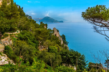 A view from the island of Capri, Italy towards the natural arch and the Amalfi coast in the distance