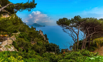 Fototapeta na wymiar A panorama view of the natural arch and the Amalfi coast from the island of Capri, Italy