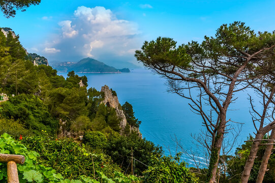 A stunningly beautiful view of the natural arch and the Amalfi coast from the island of Capri, Italy