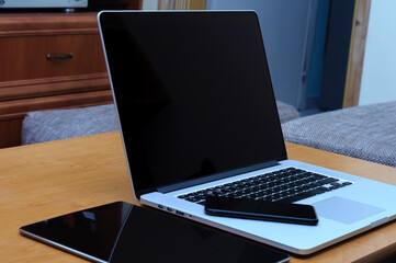 View on a laptop pc and a smartphone and a tablet on a desk in a home office