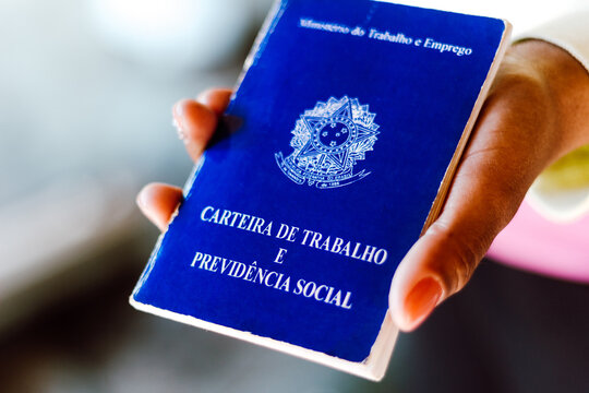 July 4, 2020, Brazil. Woman holds his Brazilian document work and social security (Carteira de Trabalho e Previdencia Social).