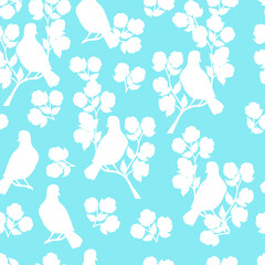 Seamless pattern with white bird silhouettes on a flowering branch