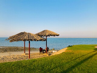 beach with umbrellas made by palm leaves 