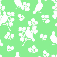 Seamless pattern with white bird silhouettes on a flowering branch
