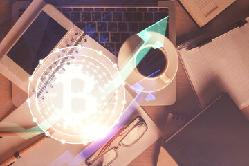 Double exposure of blockchain theme hologram over table with phone. Top view. Crypto technology...