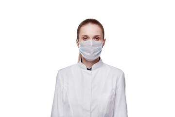 A female doctor, looking at the camera, puts a medical mask on her face.